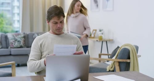 4k video footage of a young woman helping her husband while he works from home