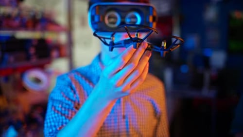 Teen Wearing VR Headset Holding Drone