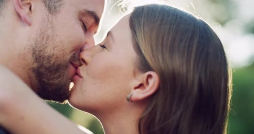 4k video footage of a happy young couple kissing in the park