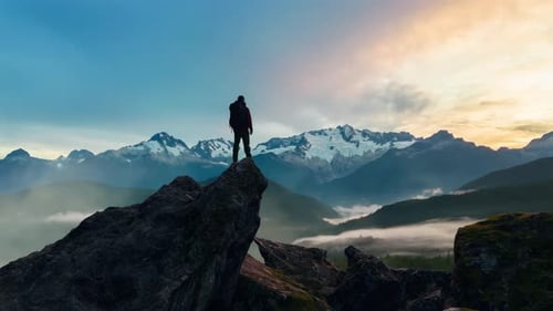 Epic Adventure Composite of Man Hiker on Top of a Rocky Mountain