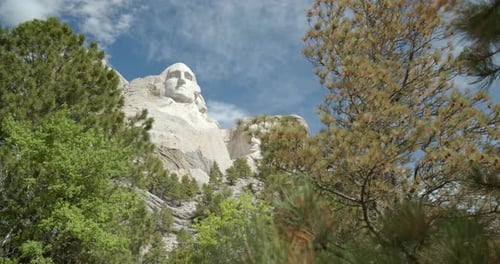 Mount rushmore national memorial faces emerging through South Dakota trees