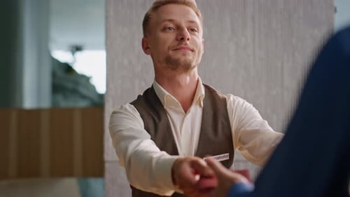 Happy Young Adult Male Employee Giving Documents