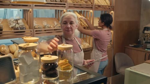 Two Female Workers Preparing Bakery for Opening