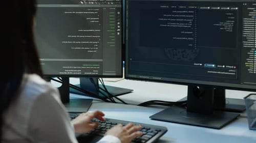 Software Developer Monitors Cybersecurity Risks in Server Room