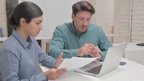 Multi Ethnic Business People Doing Paperwork in Office