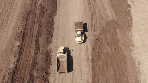 Aerial View of Construction Dump Trucks with Soil