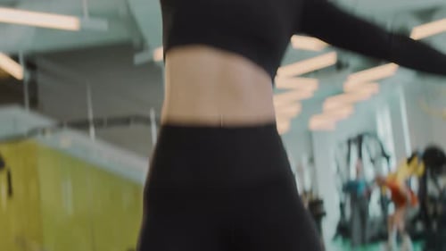 Fitness Woman Lifting Dumbbell at Gym