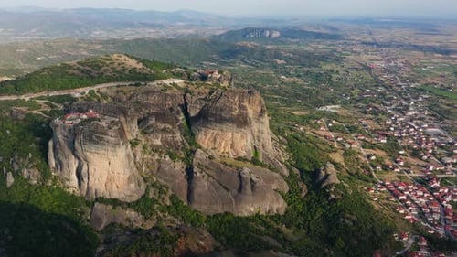 Sunlight Illuminating Meteora Monasteries Showcases Their Grandeur Atop Towering Rock Formations