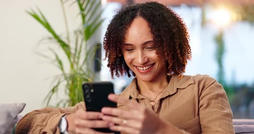 Woman, phone and laughing on sofa in home with text message, funny blog post or social media meme