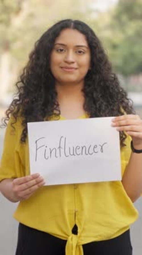 Young Adult Posing with a Sign Outdoors