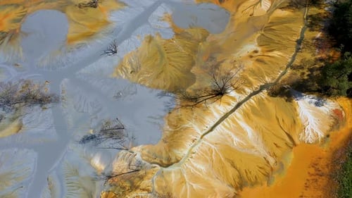 Aerial view of acid mine water drainage flow, toxic mine waters polluting nature