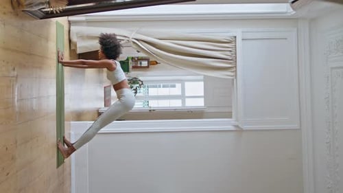 Woman Doing Yoga Stretch in Apartment