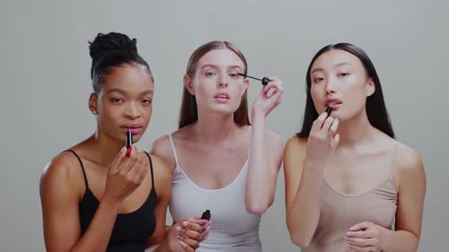 Young Women Applying Makeup in Studio
