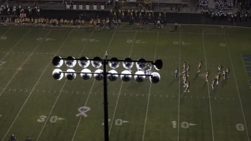 American Football Teams of Play Game at Night Time Drone Aerial Zoom Shot