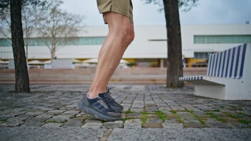 Sporty Legs Start Running in Urban Park Closeup Fit Male Athlete Workout Cardio