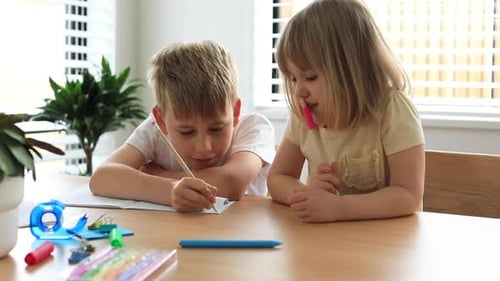 Children Doing Homework Together at Table