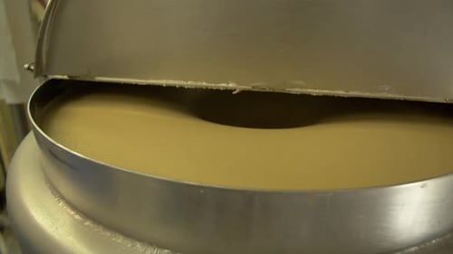Metal Vat with Pudding Substance being Stirred