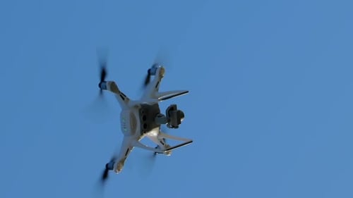 Drone Ascending Against a Clear Blue Sky