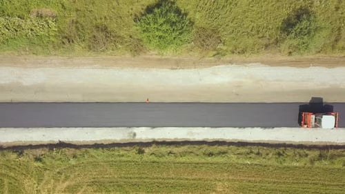 Aerial View of New Road Construction with Steam Roller Machine at Work