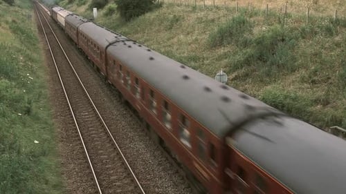 High Angle Aerial View Of Passenger Train Traveling On Tracks