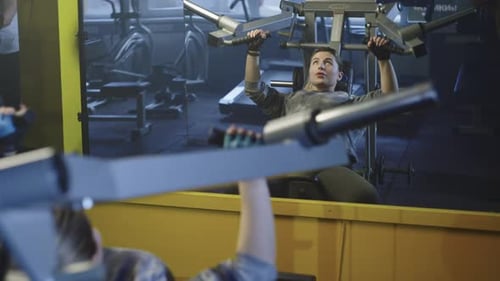 Caucasian Woman Working Out in the Morning on the Exercise Machine in the Gym