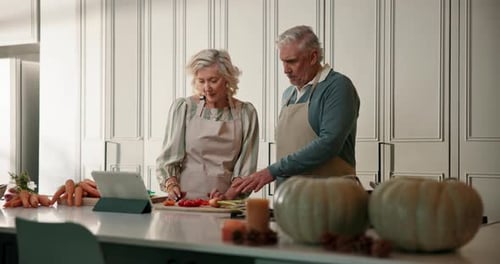 Senior Couple Cooking Together in Modern Kitchen