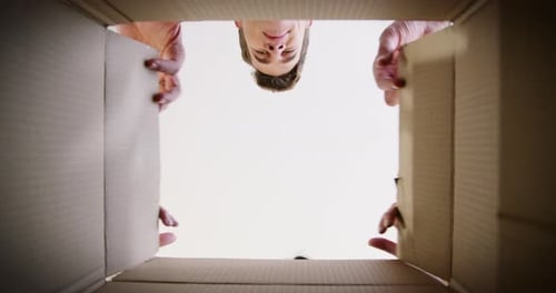Excited Couple Opens Box, Looks Inside, Laughing