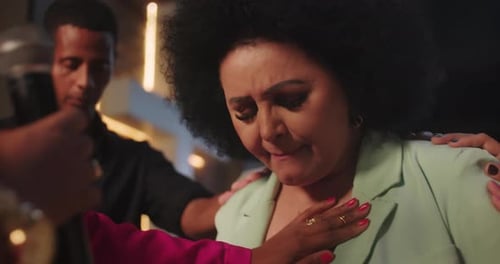 Women Talking and Hugging Indoors at Event