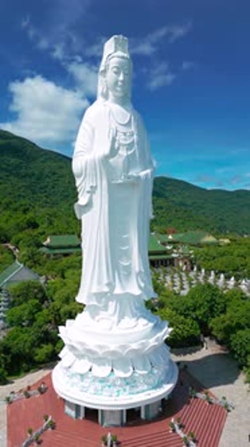 A Stunning Aerial View of the Lady Buddha Statue Amidst Lush Greenery in Da Nang Showcasing Serene
