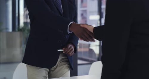Business Professionals Shaking Hands in Modern Office