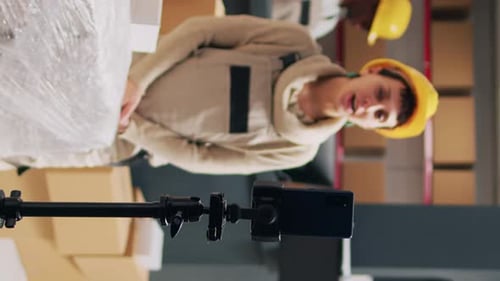 Vertical Video Supervisor Recording Advertisement Video in Depot