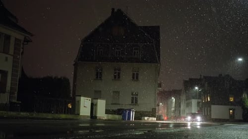 Rainy Night in City Street with Passing Car