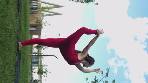 Woman Doing Yoga Outdoors in Urban Park