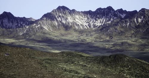Majestic Snow Capped Mountains Rise Above a Serene Valley Landscape