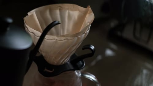 Water poured into glass coffee maker close up