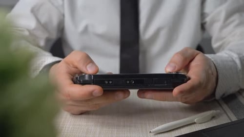 Playing Video Game with Handheld Console at Office Using Joystick