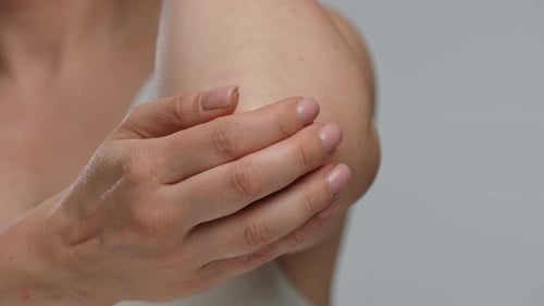 Close Up Image of Woman Holding Her Painful Elbow