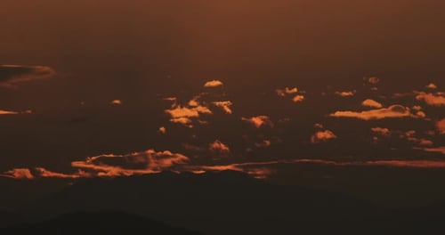 Vibrant Sunrise over Mountain Landscape with Clouds
