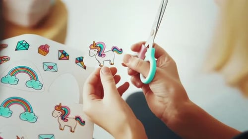 Close up of parents with children cut out toy ibex on paper with scissors