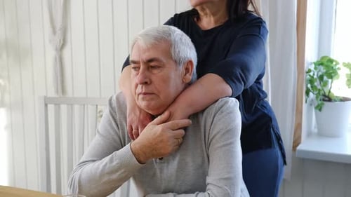 Loving Woman Embracing her Husband from Behind Indoors