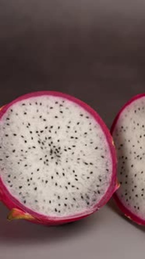 Vertical Video, Dragon Fruit Cut In Half On A Gray Plate