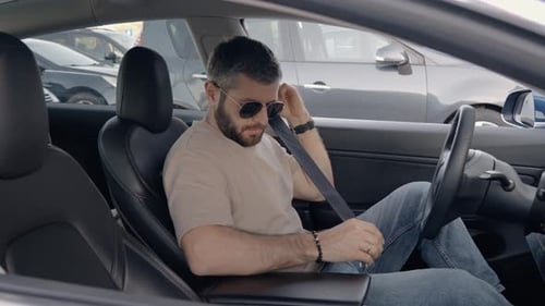 Man Securely Fastening Seat Belt in Modern Car Interior