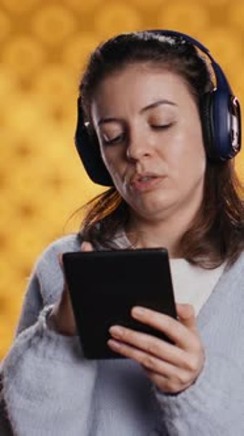 Vertical Video Woman Buying Electronic Books for Ereader Typing on Screen Atudio Background