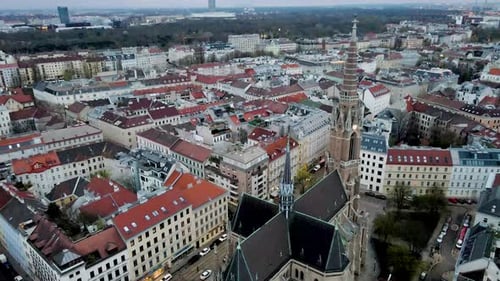 4K Aerial/Drone Rise over Church in Vienna, Austria. Camera tilts down.