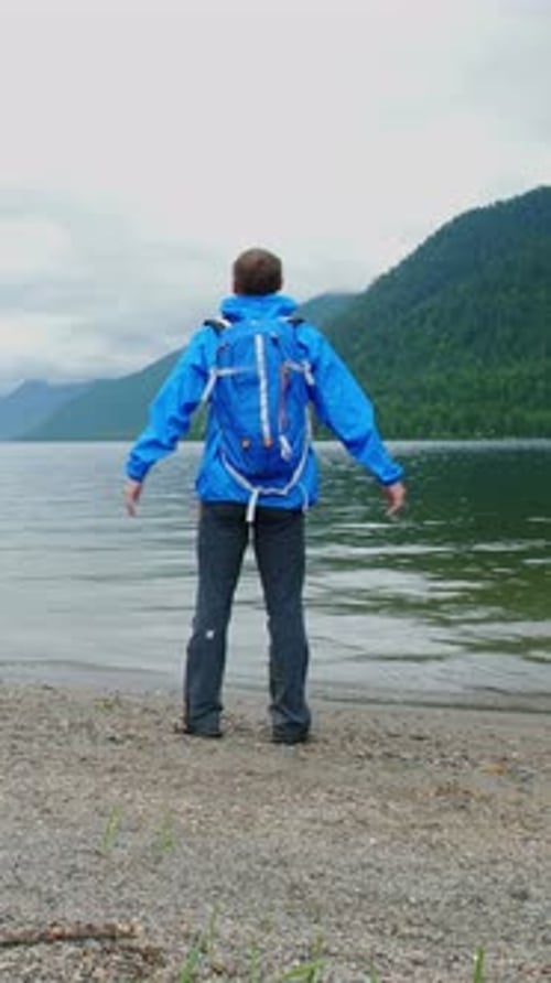 Enjoying a Peaceful Walk Along the Shore of a Serene Lake in the Mountains