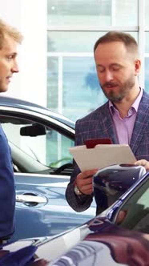 Stylish Seller Showcases Luxurious Car Interior to Interested Customer