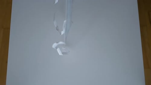 Face Masks Falling onto White Surface