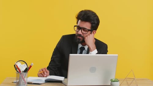 Business Man has Idea Writing in Notebook