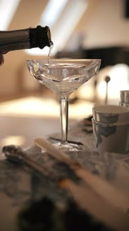 Sparkling Beverage Being Poured Into Crystal Coupe Glass
