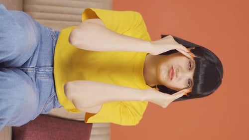 Adult Woman Massaging Temples While Sitting on Couch